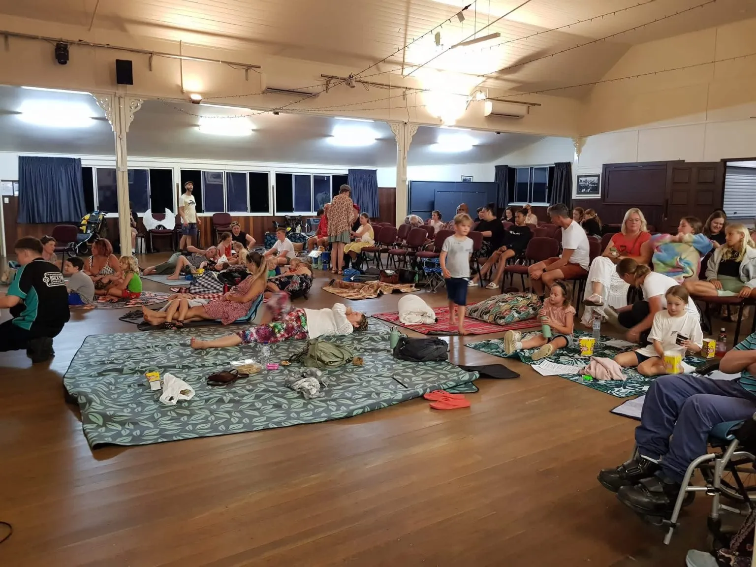 A colourful crowd dancing at a Palmwoods community night